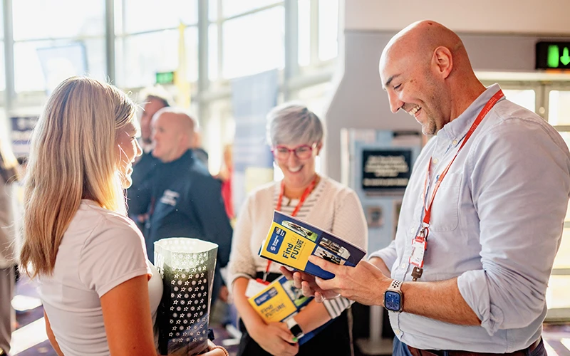 Teachers and student looking at prospectus