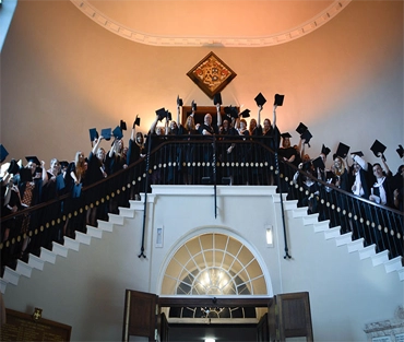 All graduate students standing along the stairs in St Chads Church 