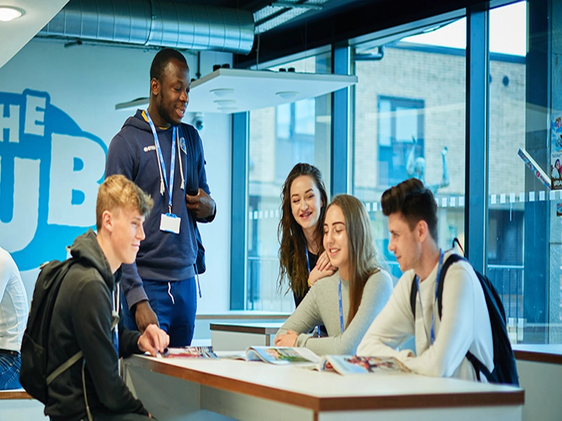 Group of students chatting around a table