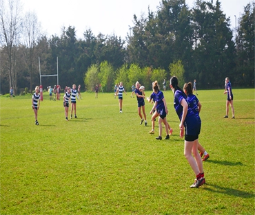 Women's rugby match in action on college field