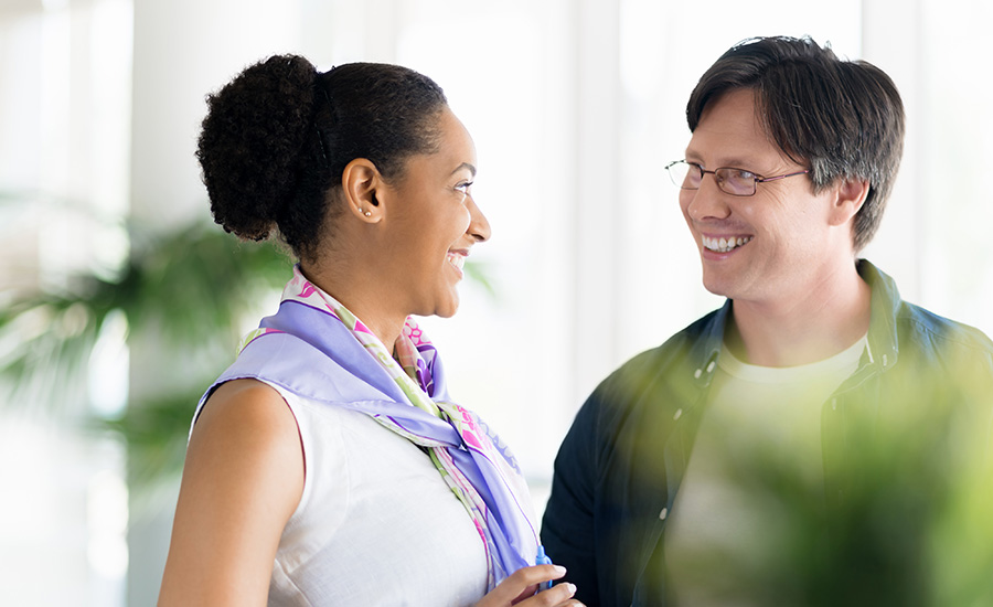 stock photo two collegues standing next to each other in a office