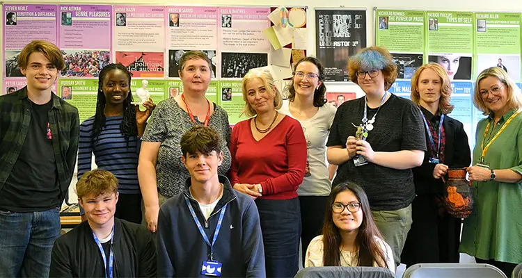 Teacher and students smiling in a group