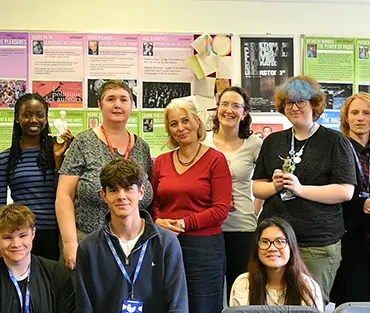 Teacher and students smiling in a group