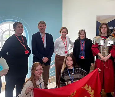 Students standing with staff and the Principal