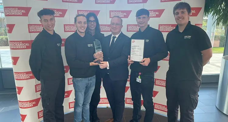 Group of apprentices students receiving trophy from employer