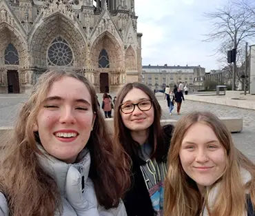 Students selfie in front of Notre Dame in Paris