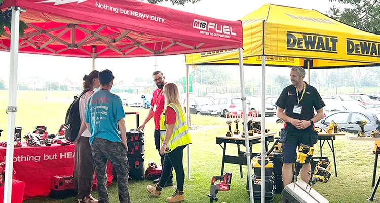 A group of people standing at a supplier stand