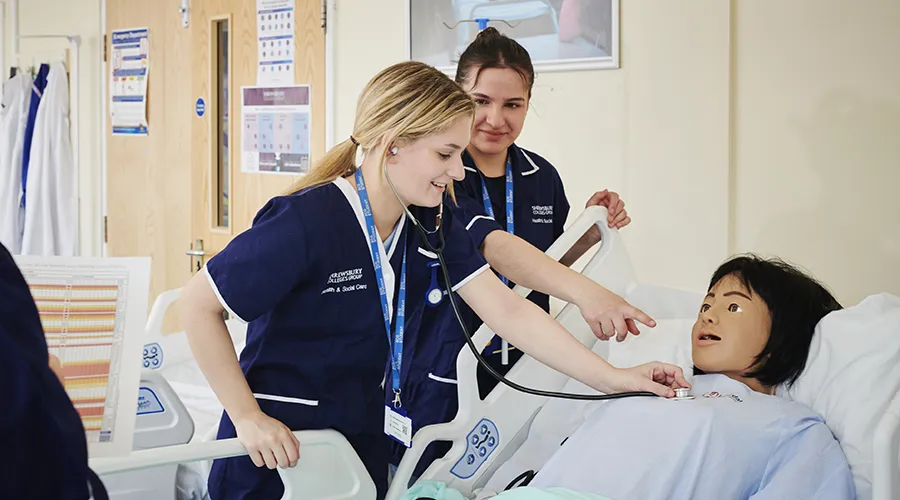 Students in ward setting using practice dummy