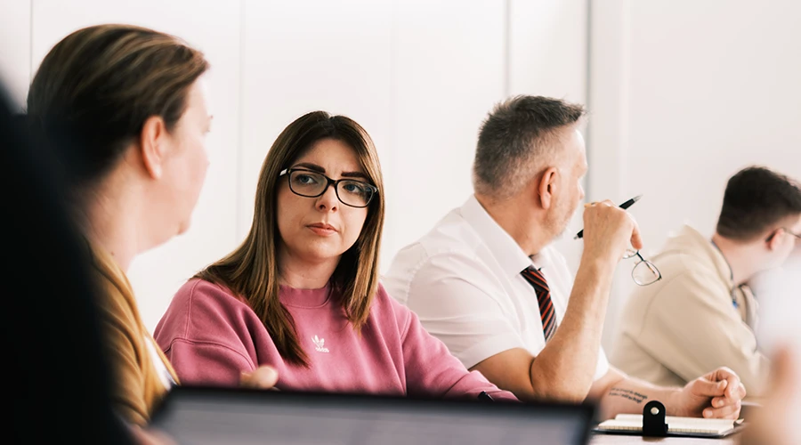 Four adult learners in a classroom