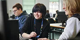 Student and teacher in front of computer