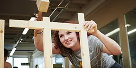 Student hammering wooden joint into place